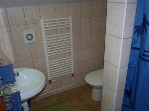 a bathroom with a white toilet and a sink at Penzión Nezábudka in Stropkov