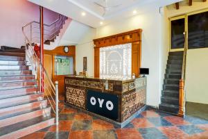 a lobby with stairs and a stage in a building at Super OYO 77115 Flagship Hotel Vaishnavi Palace in Hyderabad