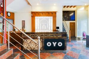 a lobby with an ovo sign on the wall at Super OYO 77115 Flagship Hotel Vaishnavi Palace in Hyderabad