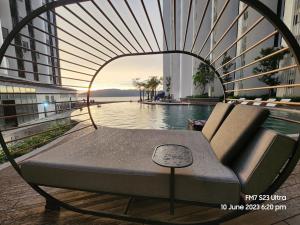 a bed sitting next to a pool in a building at The Shore Ns Studio Suites Sea View in Kota Kinabalu