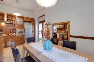 a dining room and kitchen with a table and chairs at City Apartment With Garden - Happy Rentals in Rijeka
