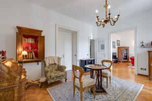 a living room with a table and chairs at City Apartment With Garden - Happy Rentals in Rijeka