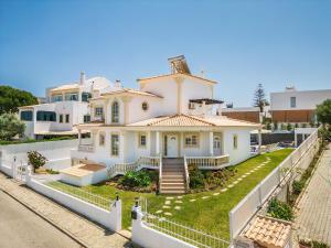 a large white house with a white fence at Casa Vela by OCvillas in Albufeira