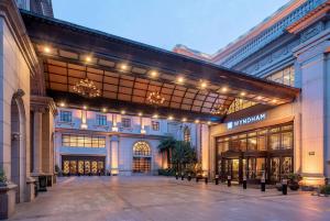 a large building with a shopping mall with lights at Wyndham Shanghai Hongqiao in Shanghai