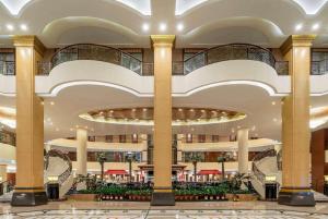 a large building with columns and a lobby at Wyndham Shanghai Hongqiao in Shanghai