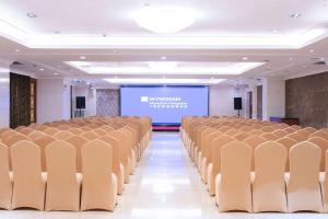 an empty room with chairs and a projection screen at Wyndham Shanghai Hongqiao in Shanghai