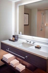 a bathroom with a sink and a large mirror at Grand Hyatt Denver in Denver