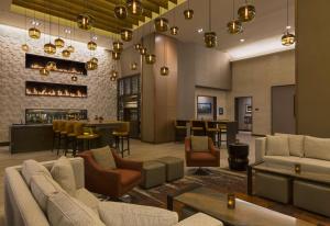 a lobby with couches and chairs and a bar at Grand Hyatt Denver in Denver