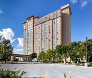 a large building with a parking lot in front of it at Hyatt Regency Wichita in Wichita