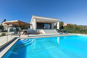 una piscina di fronte a una casa di Secluded Elegance at Villa Giem - 4 Bedrooms - Unmatched Sea Views - Private Pool & Lush Gardens - Dassia a Dafnila