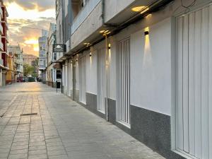 an empty street in a city with a building at Reinapart Valencia Beach in Valencia