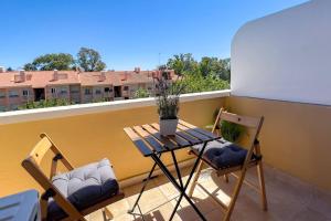 a table and two chairs on a balcony at OleHolidays 624 Duplex Carib Playa 200 mts. playa in Marbella