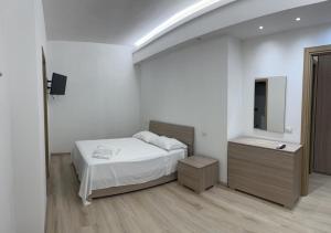 a bedroom with a bed and a dresser and a mirror at Villa Milano Apt. n. 1 in Milan