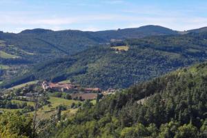 a house in the middle of a valley with trees at Maison de vacances en Ardèche in Pailharès