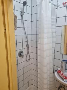 a shower with a shower curtain in a bathroom at Fellini 8 1/2 in Haifa