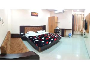 a bedroom with two beds and a desk in it at Hotel Pragati, Chanderi, MP in Chanderi