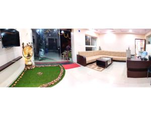 - un salon avec un canapé et une télévision dans l'établissement Hotel Pragati, Chanderi, MP, à Chanderi