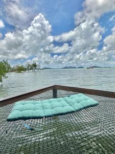 a blue pillow on a net in the water at Lanta Sabai Day House in Ko Lanta