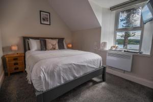 a bedroom with a large bed and a window at Coolin View in Portree