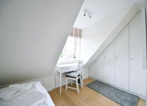 - une chambre avec un bureau, un lit et une fenêtre dans l'établissement Südstrandidyll, à Wyk auf Föhr