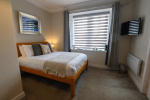 a small bedroom with a bed and a window at Coolin View in Portree