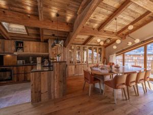 a dining room with a wooden ceiling and a table and chairs at Chalet Courchevel, 6 pièces, 10 personnes - FR-1-568-33 in Courchevel