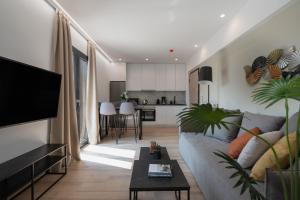 a living room with a couch and a table at The Edge - Luxury Residences in Athens