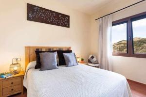 a bedroom with a large bed and a window at Casa en Anaga Senderismo naturaleza y desconexión in Santa Cruz de Tenerife