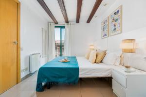 - une chambre avec un lit et une table bleue dans l'établissement Lodging Apartments Liceu G1, à Barcelone