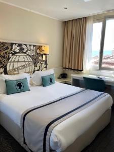 a hotel room with a large bed and a window at Napoleon in Ajaccio