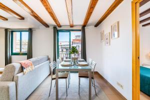a living room with a table and a couch at Lodging Apartments Liceu G1 in Barcelona