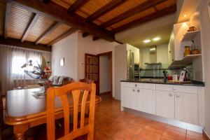 a kitchen with a table and a dining room at El Rincón de Antonio in Monfarracinos +18 photos