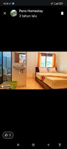 a picture of a room with a bed and a bathroom at Peno Homestay in Sumberbuluh