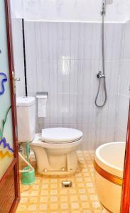 a bathroom with a toilet and a shower at Peno Homestay in Sumberbuluh