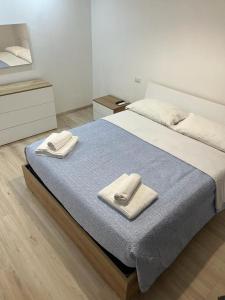 a bedroom with a bed with two towels on it at Villa Milano Apt. n. 3 in Milan +10 photos