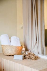 a table with towels and a candle on it at The Nest by Cooking and Nature in Alvados