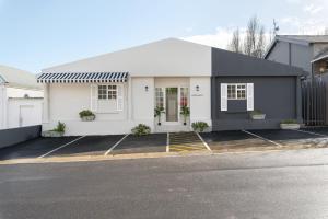 een wit en zwart huis met een parkeerplaats bij Neighbourgood Franschhoek in Franschhoek