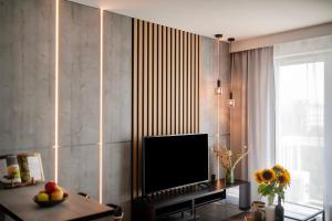 a living room with a flat screen tv on a wall at EASY RENT Apartments - Kompozytorów Polskich 51, Free Parking, 24h Check-in in Lublin
