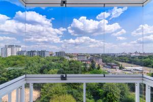 a view of the city from the balcony of a building at EASY RENT Apartments - Kompozytorów Polskich 51, Free Parking, 24h Check-in in Lublin +12 photos