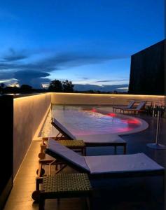 a swimming pool on the roof of a building at night at Luxury Paiva Flat in Recife