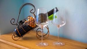 two wine glasses and a purse on a table at Gorski kotar - Pansion (Kozji Vrh, Čabar) in Kozji Vrh