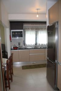 a kitchen with a stainless steel refrigerator and a table at Charming Religious House II in Fátima