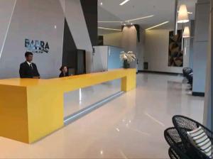a man standing at a counter in a lobby at Luxury Paiva Flat in Recife