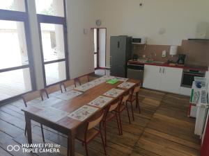 a kitchen with a long wooden table and chairs at Gite d'Etape de Chirac in Chirac