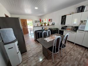 a kitchen with a table and chairs in a room at Chácara Vale Por do Sol in Catimbau
