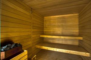 a sauna with wooden walls and wooden shelves at La Perle de Domme in Sarlat-la-Canéda