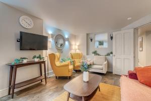 a living room with a couch and chairs and a tv at Stay Covent Garden in London