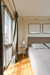 Postel nebo postele na pokoji v ubytování Visit Nida Apartments