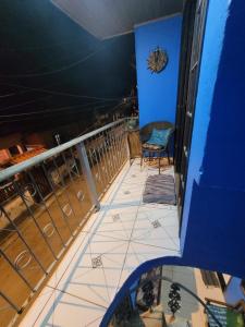 a view of a balcony with a chair and blue walls at Suite de Lane e Mu in Abraão