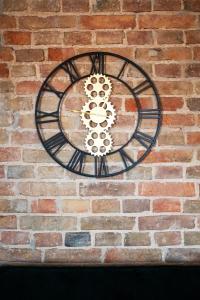 a clock on the side of a brick wall at EASY RENT Apartments - Okopowa, Centrum 24h Check-in in Lublin